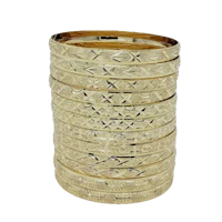 a stack of gold bangles on a black background